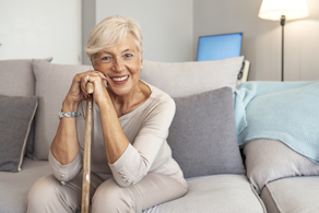 Life Assure Senior Woman Sitting In Chair And Laughing With Caregiver Nurse Blog